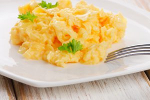 Scrambled eggs with fresh herbs. Selective focus